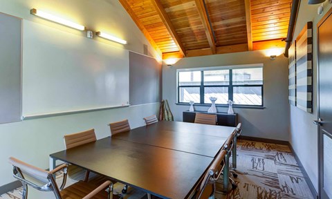 a meeting room with a long table and chairs at The Lakes Apartments, Bellevue, 98007